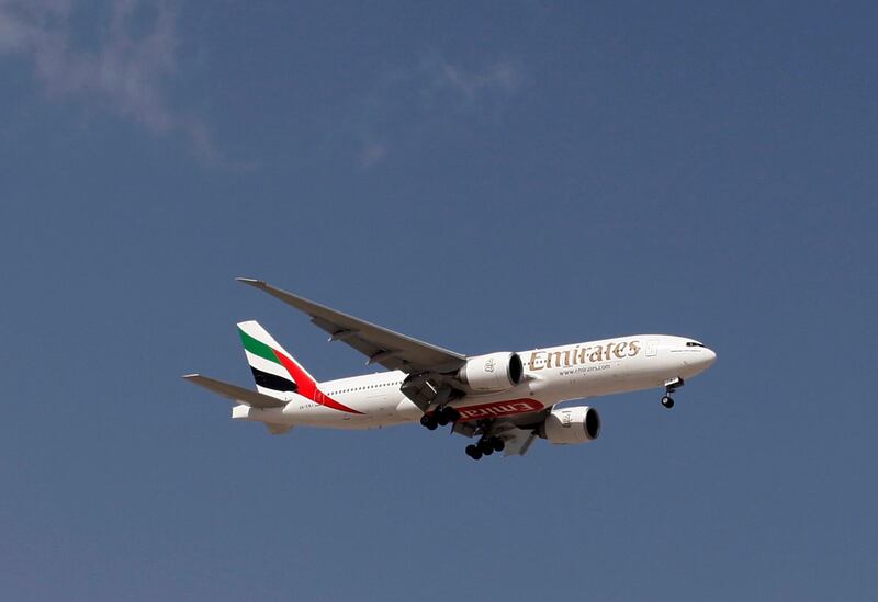 An Emirates Airlines plane lands at the Emirates terminal at Dubai International Airport, February 6, 2012. REUTERS/Jumana El Heloueh (UNITED ARAB EMIRATES - Tags: TRANSPORT TRAVEL BUSINESS)