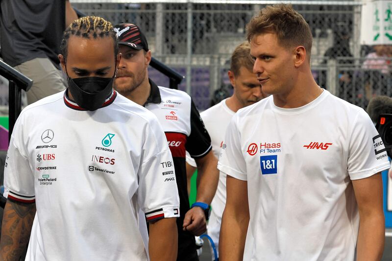 Lewis Hamilton chats Haas driver Mick Schumacher after the drivers' parade ahead of the 2022 Saudi Arabia Grand Prix. AFP