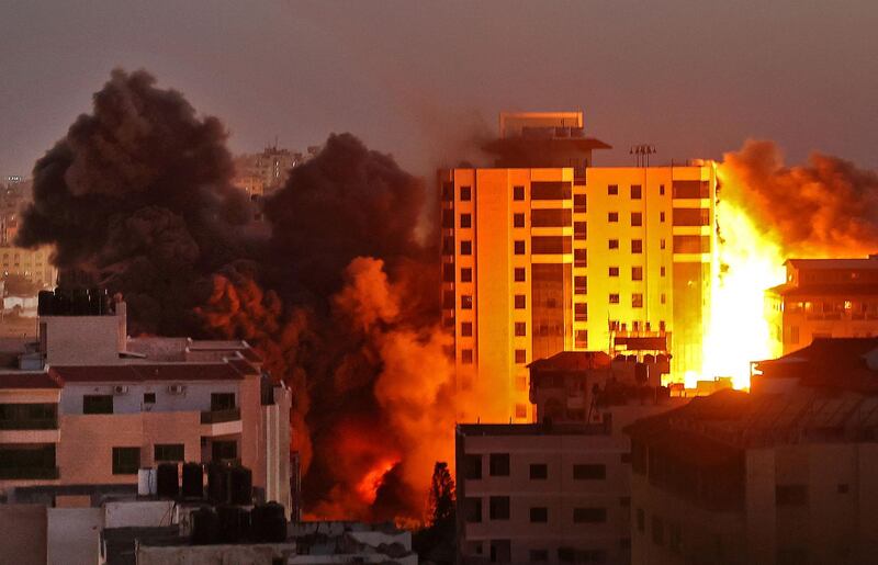 Fire engulfs a building hit during an Israeli air strike in Gaza on May 11, 2021. AFP