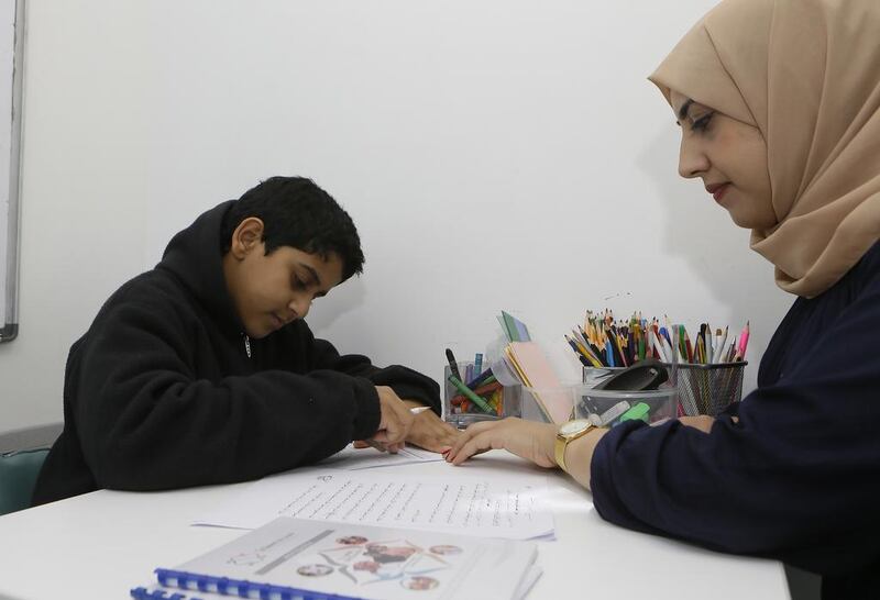  Zaid Al Jaberi, one of the pupils who has learning difficulties, with Alaa Shatnawi, an Arabic teacher at Taleem Centre. Jeffrey E Biteng / The National )  Editor’s Note;  ID 25240

