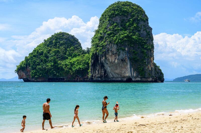 Tourists walk along Phra Nang beach in Krabi. Thailand has resumed quarantine-free travel for vaccinated tourists after the Test & Go programme was suspended owing to the fast-spreading Omicron Covid-19 variant. AFP