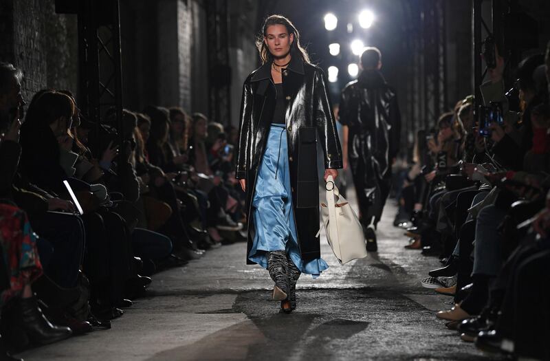 Models present creations by fashion house Rejina Pyo during the catwalk show for their Autumn/Winter 2020 collection on the second day of London Fashion Week in London on February 15, 2020. (Photo by DANIEL LEAL-OLIVAS / AFP)