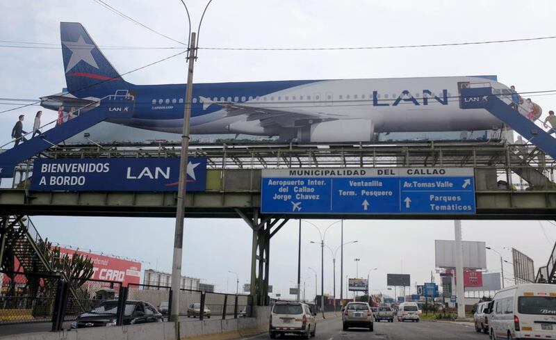 A billboard shows a LAN Airlines plane, a member of Latam Airlines, near the Jorge Chavez airport in Callao, Peru. Latam is bringing in a new passenger ticket pricing model. Mariana Bazo / Reuters