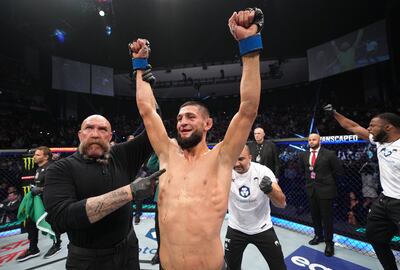 Khamzat Chimaev has his arm raised after his decision victory over Gilbert Burns in their welterweight fight at UFC 273 at VyStar Veterans Memorial Arena on April 09, 2022. Zuffa LLC

