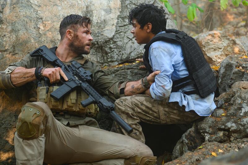 This image released by Netflix shows Chris Hemsworth, left, and Rudhraksh Jaiswal in a scene from "Extraction," premiering this week on Netflix. (Jasin Boland/Netflix via AP)