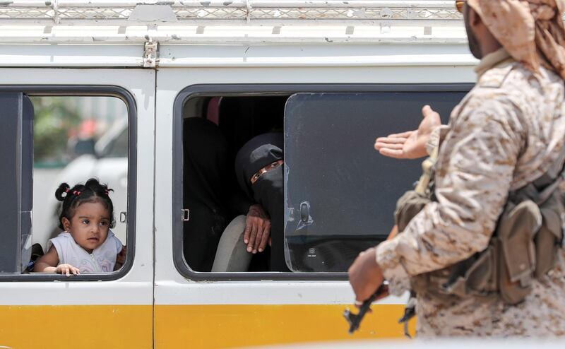 A Yemeni soldier speaks to a woman riding in a bus in Mukalla. AFP