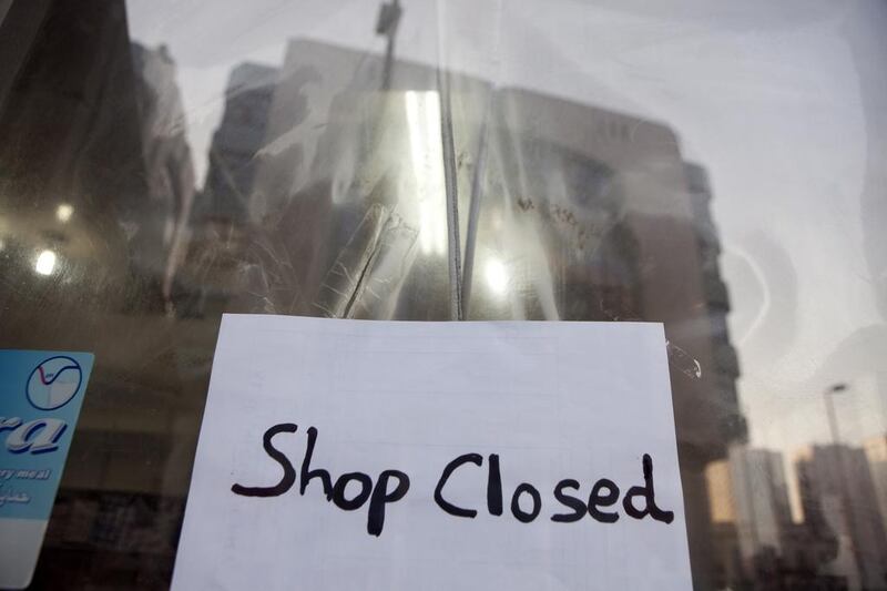 A ‘closed’ sign announces a shuttered convenience store in Abu Dhabi. Silvia Razgova / The National