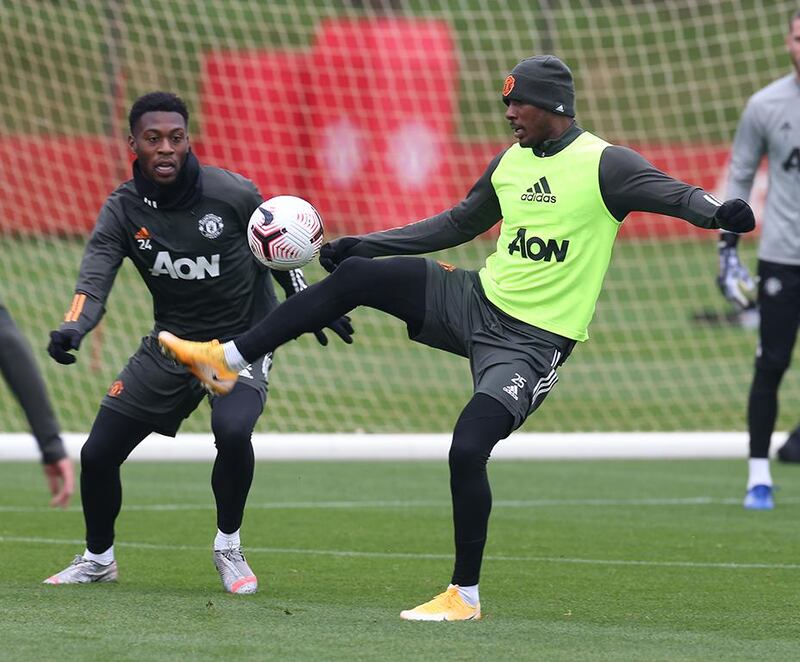 MANCHESTER, ENGLAND - OCTOBER 02: (EXCLUSIVE COVERAGE)  Timothy Fosu-Mensah and Odion Ighalo of Manchester United in action during a first team training session at Aon Training Complex on October 02, 2020 in Manchester, England. (Photo by Matthew Peters/Manchester United via Getty Images)