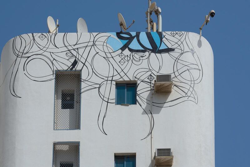 The French-Tunisian artist El Seed begin's his latest mural on a residential building in Ajman's Al Bustan neighbourhood.