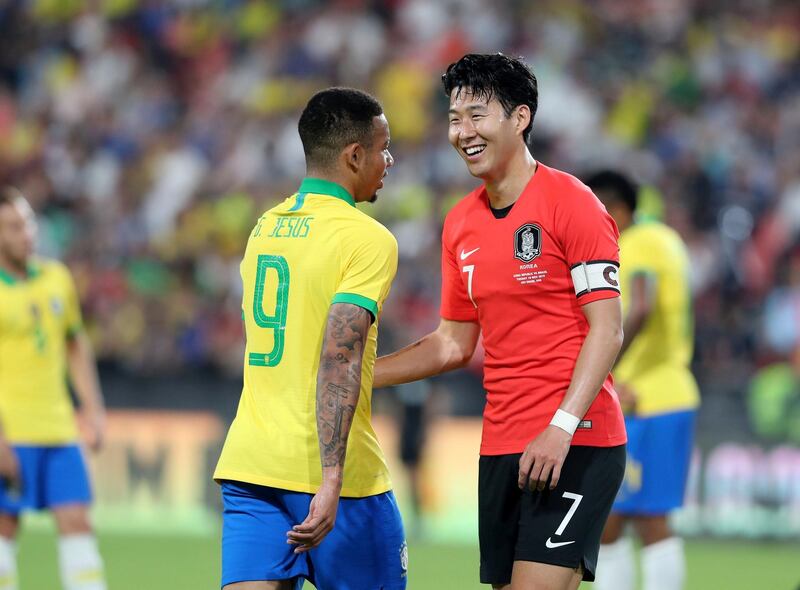 Abu Dhabi, United Arab Emirates - November 19, 2019: Brazil's Gabriel Jesus and South Korea's Son Heung-min share a joke during the game between Brazil and South Korea. Tuesday, November 19th, 2017 at Mohammed Bin Zayed Stadium, Abu Dhabi. Chris Whiteoak / The National