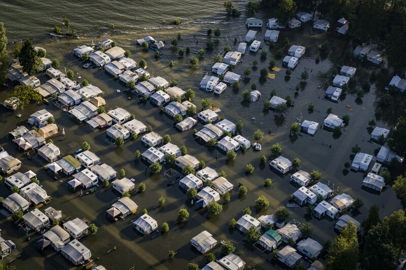 Tents and cars in a flooded camp site in Cheseaux-Noreaz on the eastern shore of Lake Neuchatel, Switzerland.