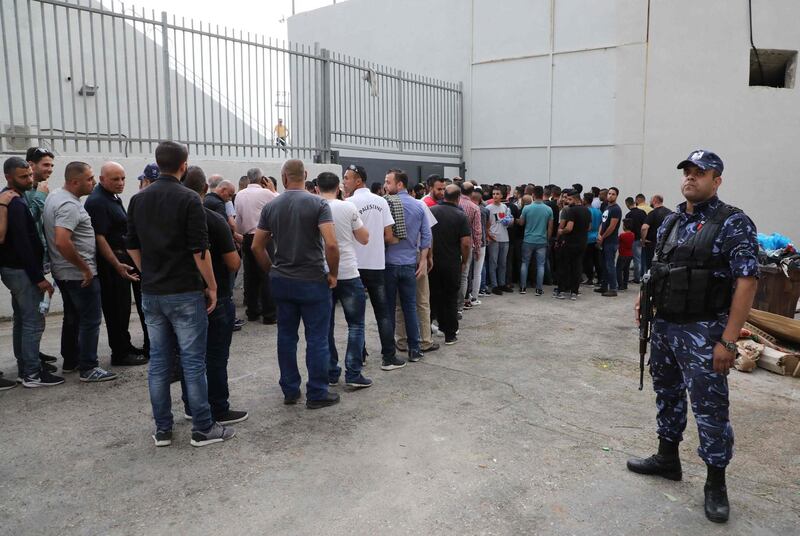Palestinian football fans queue up outside the stadium. AFP