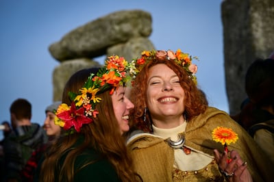 Revellers at Stonehenge wear red and yellow flower crowns to celebrate the summer solstice. Photo: Finnbarr Webster / Getty Images