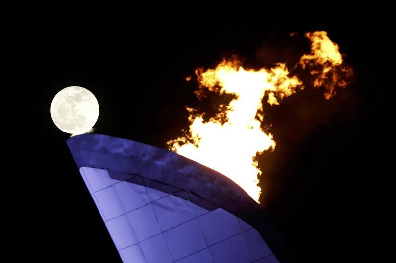 The moon rises behind the cauldron at the Olympic Park on Saturday. Gary Hershorn / Reuters