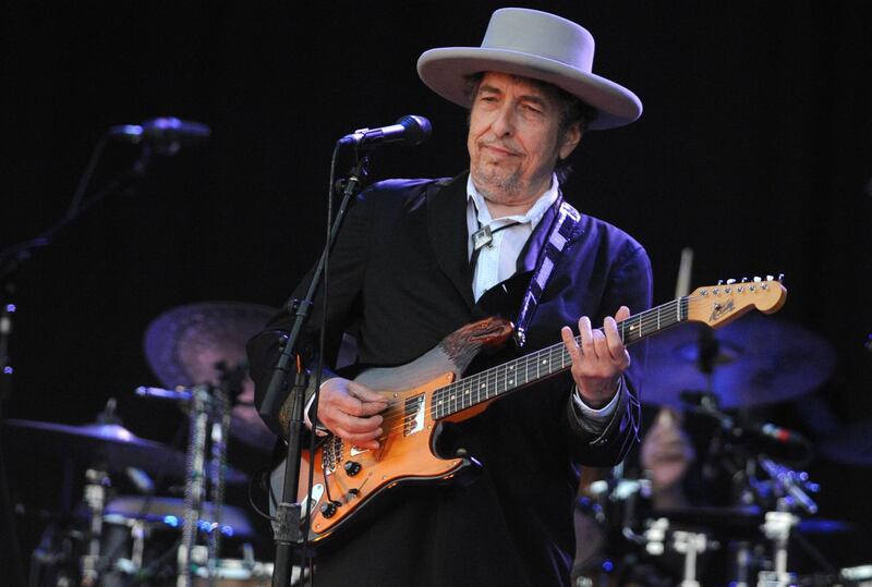 (FILES) In this file photo taken on July 22, 2012, Bob Dylan performs during the 21st edition of the Vieilles Charrues music festival in Carhaix-Plouguer, western France.   Dylan surprised fans overnight into March 27, 2020, by releasing his first original music in eight years, a 17-minute ballad about the assassination of John F. Kennedy. / AFP / Fred TANNEAU
