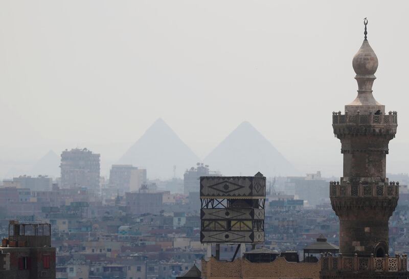 A view of Old Cairo in Egypt with a mosque minaret and the Great Pyramids. Reuters