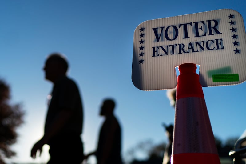 Voters pass by a sign outside a polling site in Warwick, Rhode Island after casting their ballots on the last day of early voting before the midterm election. AP 