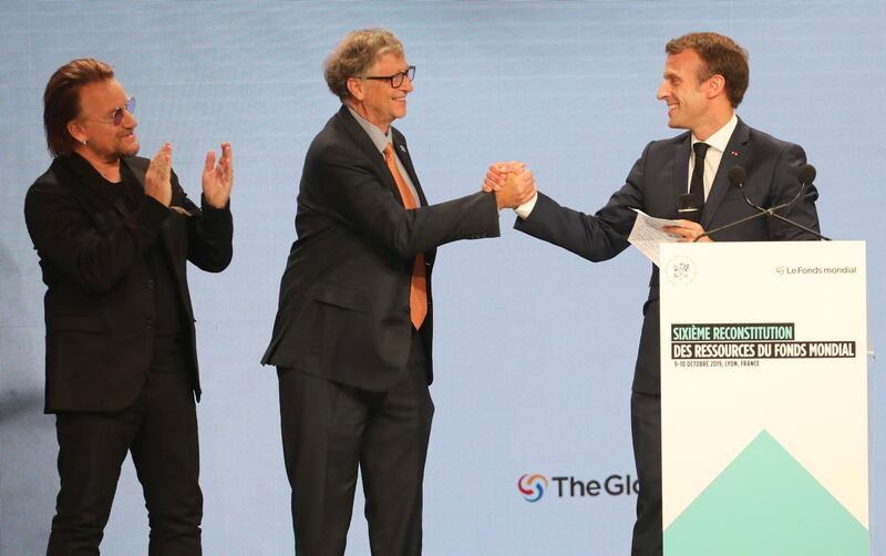 From left: U2 singer Bono, Philanthropist and Co-Chairman of the Bill and Melinda Gates Foundation Bill Gates, and France's President Emmanuel Macron congratulate each other on stage at the Lyon's congress hall, in France. AP Photo