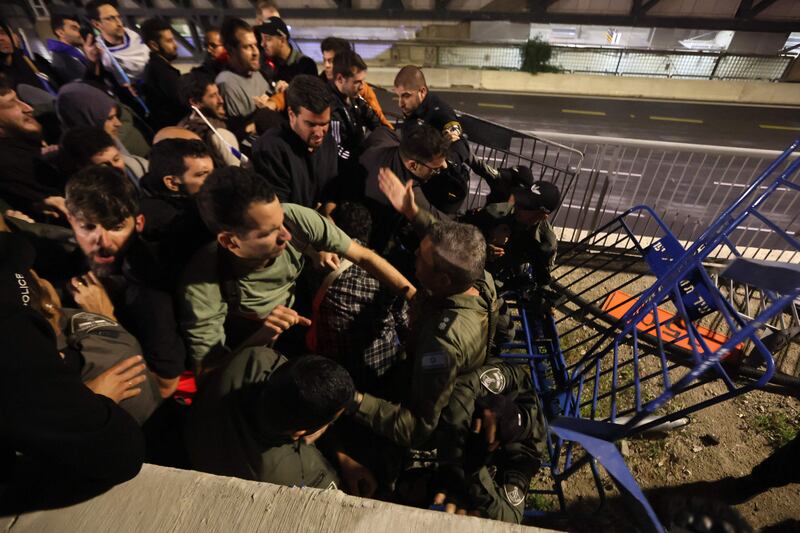 Protesters scuffle with police in Tel Aviv. AFP