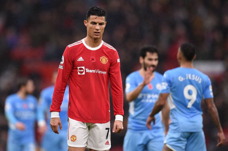 Manchester United striker Cristiano Ronaldo during the match as Manchester City players celebrate in the background. AFP