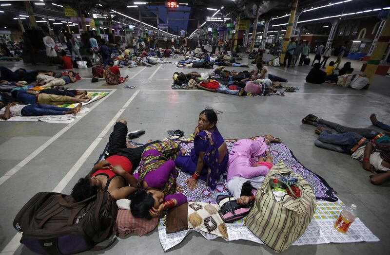 Stranded passengers rest inside a railway station after trains between Kolkata and Odisha were cancelled. Reuters