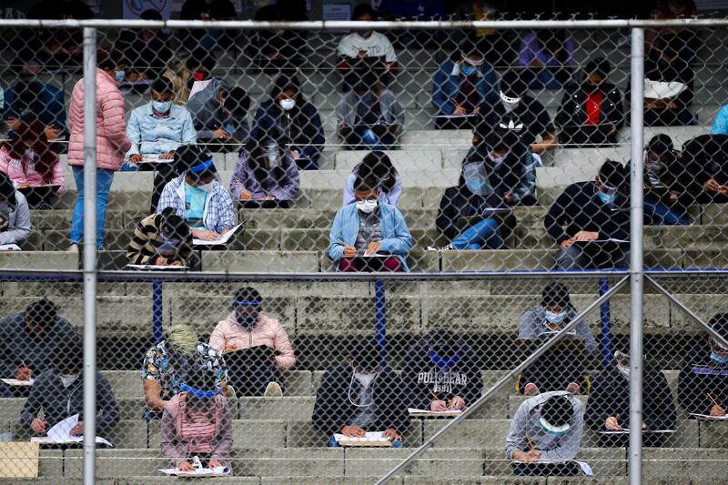 Young people maintain social distancing as they take the entrance exam for Mexico's National Autonomous University in the stands of University Olympic Stadium in Mexico City, Mexico. Reuters