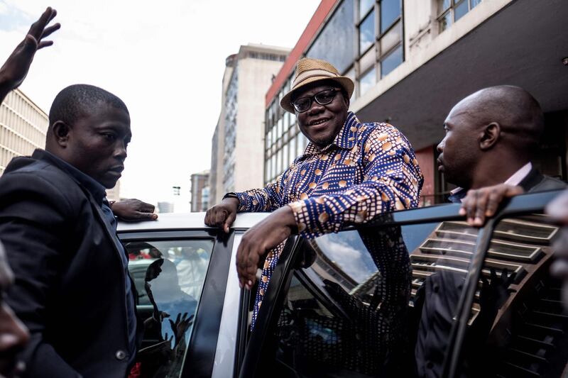 (FILES) In this file photo taken on July 31, 2018 Former Zimbabwean Finance Minister and MDC Alliance member Tendai Biti (C) greets supporters outside the MDC Alliance's headquarters in Harare.
Senior Zimbabwean opposition figure Tendai Biti was arrested as he tried to flee to neighbouring Zambia to seek asylum, his lawyer said on August 8, 2018. Biti allegedly faces charges for inciting violence over the disputed result of last week's elections.
 / AFP PHOTO / MARCO LONGARI
