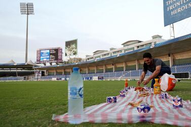 A player sets up for Iftar before the Sharjah Ramadan Cup game between MGM Cricket Club and Pacific Group in Sharjah. Chris Whiteoak / The National