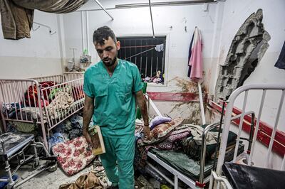 A man inspects the damage at a hospital in Khan Younis after an Israeli bombardment on Sunday. AFP
