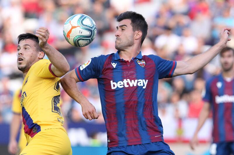 Barcelona's Carles Perez, left, clashes with Levante's Sergio Postigo in Valencia on Saturday. AP