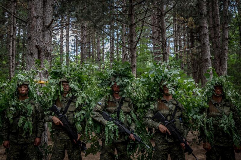 Kosovo Security Forces (KSF) new basic training recruits learn camouflage techniques while taking part in tactical exercises during the final weeks of their nine-week basic training in Ferizaj, Kosovo. Getty