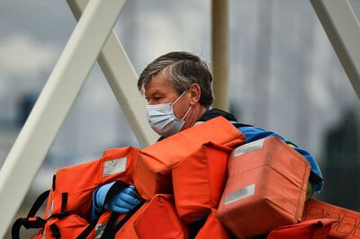 The coastguard carries life jackets for migrants. AFP