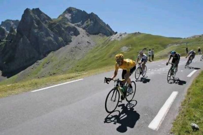 Bradley Wiggins of Britain, wearing the overall leader's yellow jersey, speeds down the Tourmalet pass.