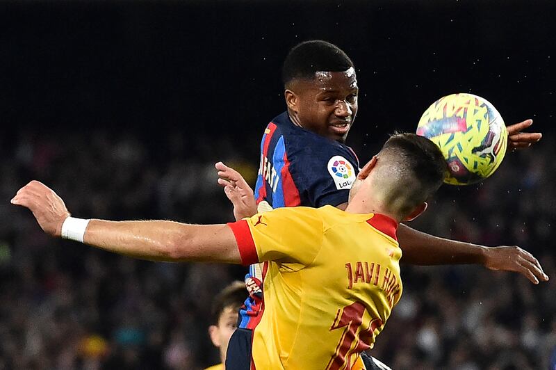 Barcelona's Spanish forward Ansu Fati vies for a header with Girona's Spanish midfielder Javier Hernandez. AFP