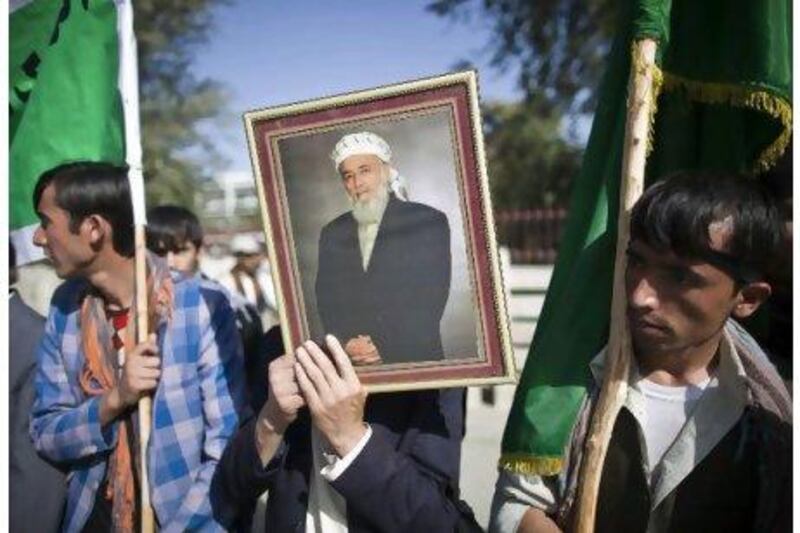 Supporters of Burhanuddin Rabbani gather outside his house in Kabul yesterday. Ahmad Masood / Reuters