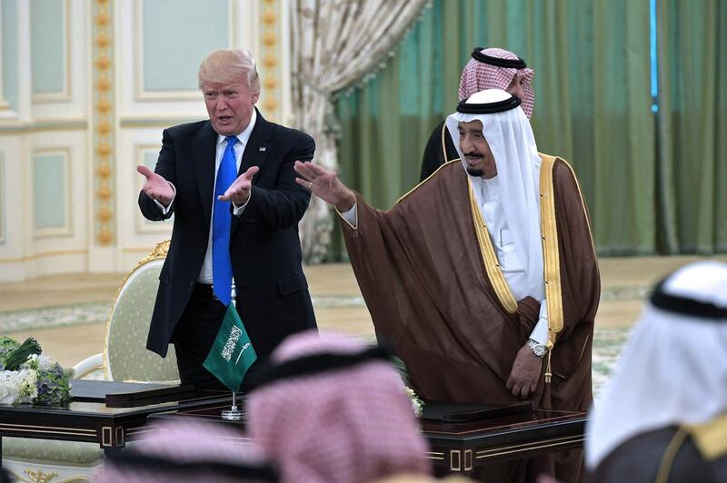 Mr Trump and King Salman gesture during a signing ceremony at the Saudi Royal Court in Riyadh on May 20, 2017. / AFP / Mandel Ngan