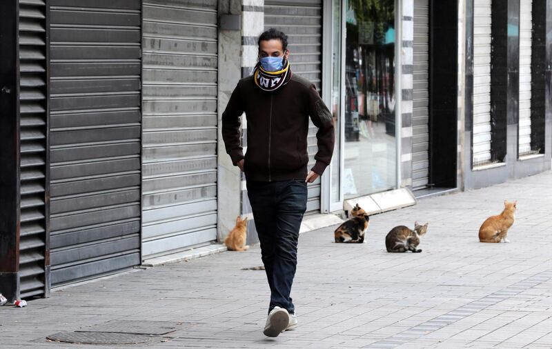 epa08318442 A Tunisia man wearing a face mask walks on a street in Tunis, Tunisia, 24 March 2020. Tunisian President Kais Saied on 23 March 2020, ordered the deployment of the armed forces on the streets to enforce general confinement and prevent gatherings of more than three people.  EPA/MOHAMED MESSARA