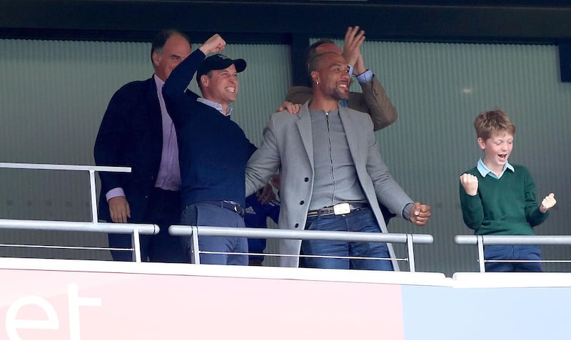 Prince William punches the air in delight as he celebrates with former Villa striker John Carew. PA Photo