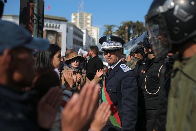 Security forces stand guard as Moroccan teachers stage a protest calling to improve wages and promotion opportunities, in Rabat, Morocco, Wednesday, Jan. 2, 2019. (AP Photo/Mosa'ab Elshamy)