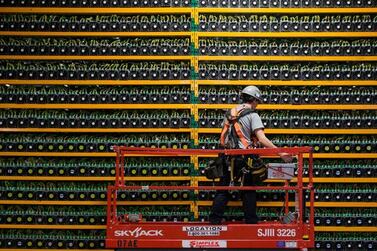 A technician inspects the back of a Bitcoin mining centre in Quebec. AFP 