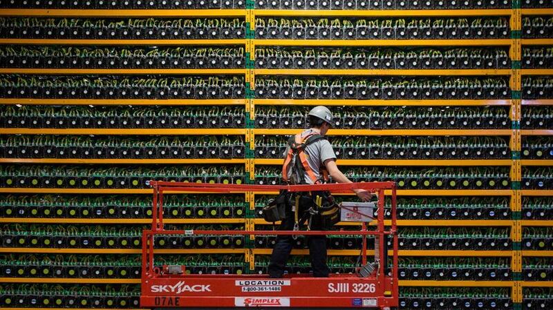 A technician inspects the back of a Bitcoin mining centre in Quebec. AFP 