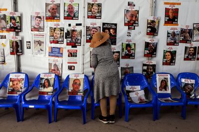 A woman looks at posters bearing images of hostages held by Hamas since October 7. Reuters