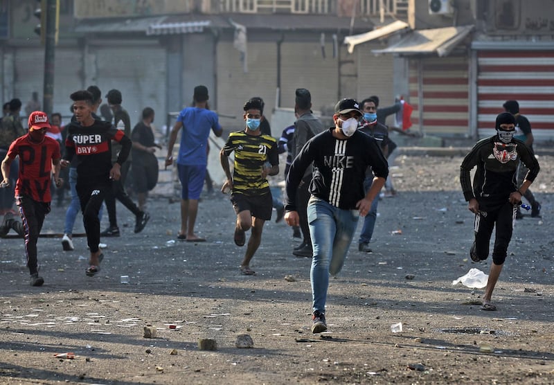 Iraqi protesters clash with Iraqi security forces at Baghdad's Khallani square during ongoing anti-government demonstrations on November 11, 2019.  AFP