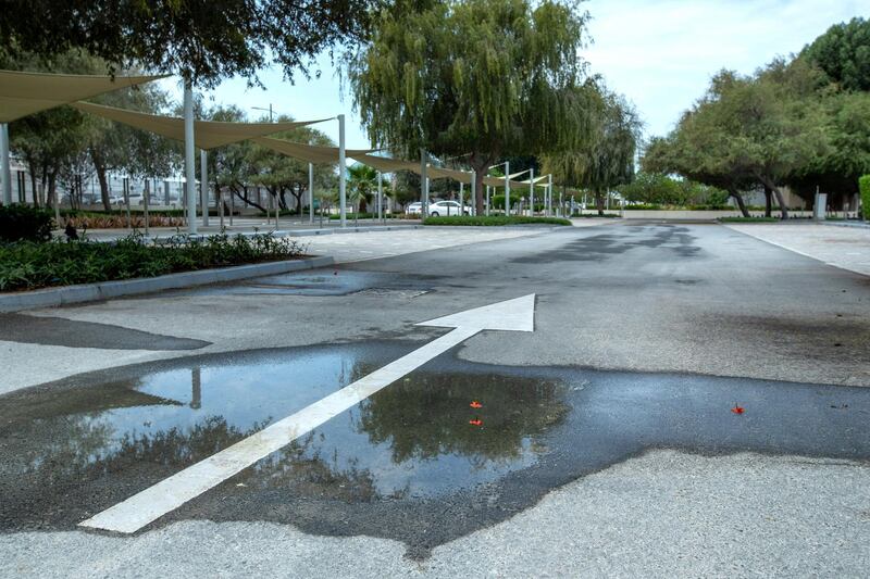 Puddles from the brief rainshowers gather on the gutters and roads in Saadiyat Island on April 28, 2021.  Victor Besa / The National.