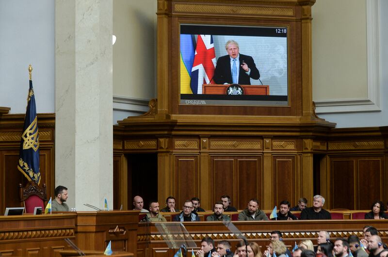 UK Prime Minister Boris Johnson addresses Ukrainian President Volodymyr Zelenskyy, left, and the country's MPs by video link. Reuters