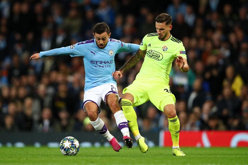 MANCHESTER, ENGLAND - OCTOBER 01: Bernardo Silva of Manchester City is challenged by Petar Stojanovic of GNK Dinamo Zagreb during the UEFA Champions League group C match between Manchester City and Dinamo Zagreb at Etihad Stadium on October 01, 2019 in Manchester, United Kingdom. (Photo by Clive Brunskill/Getty Images)