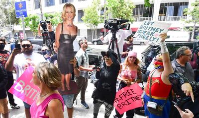 TOPSHOT - A life-size cardboard cutout of Britney Spears in seen as fans and supporters gather outside the County Courthouse in Los Angeles, California on June 23, 2021, during a scheduled hearing in Spears' conservatorship case.  Pop singer Britney Spears urged a US judge on June 23, to end a controversial guardianship that has given her father control over her affairs since 2008.
"I just want my life back. It's been 13 years and it's enough," she told a court hearing in Los Angeles during an emotional 20-minute address via videolink.
 / AFP / Frederic J. BROWN

