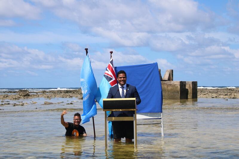 Simon Kofe, Foreign Minister of island nation Tuvalu, gives his Cop26 speech while showing the effect of rising sea levels. Reuters