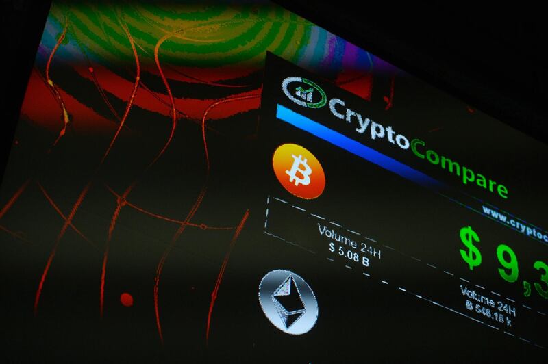 The symbols of Bitcoin and Ethereum cryptocurrencies sit displayed on a screen during the Crypto Investor Show in London, U.K., on Saturday, March 10, 2018. The meeting is the largest crypto and blockchain event for investors in the U.K. Photographer: Mary Turner/Bloomberg