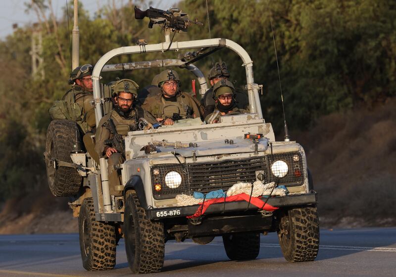 Israeli soldiers form a convoy near the security fence between Israel and Gaza, near Sderot. EPA